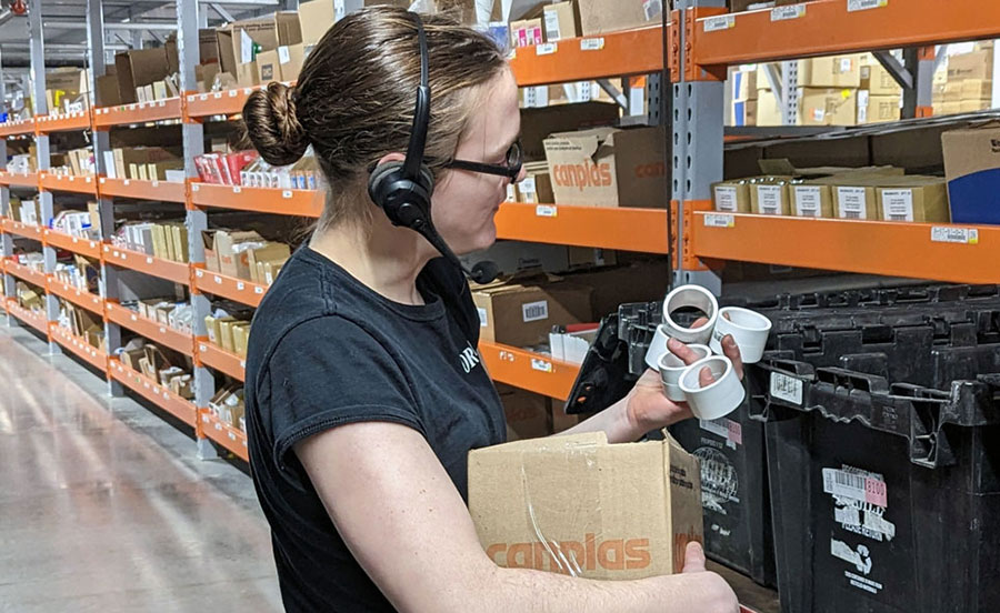 warehouse worker wearing lucas headset and picking items