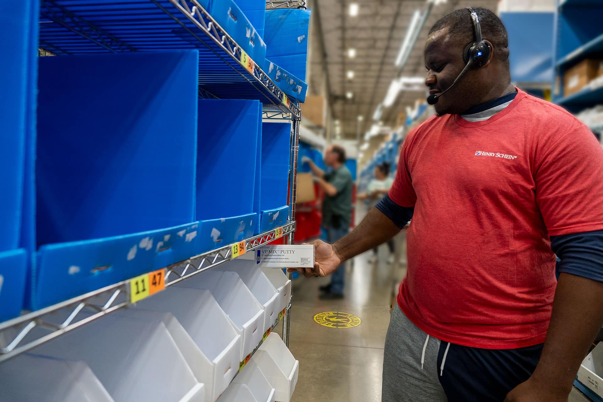 HS Pickers multiple warehouse workers using Lucas headset to pick by voice